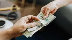 A person paying a man extra money.