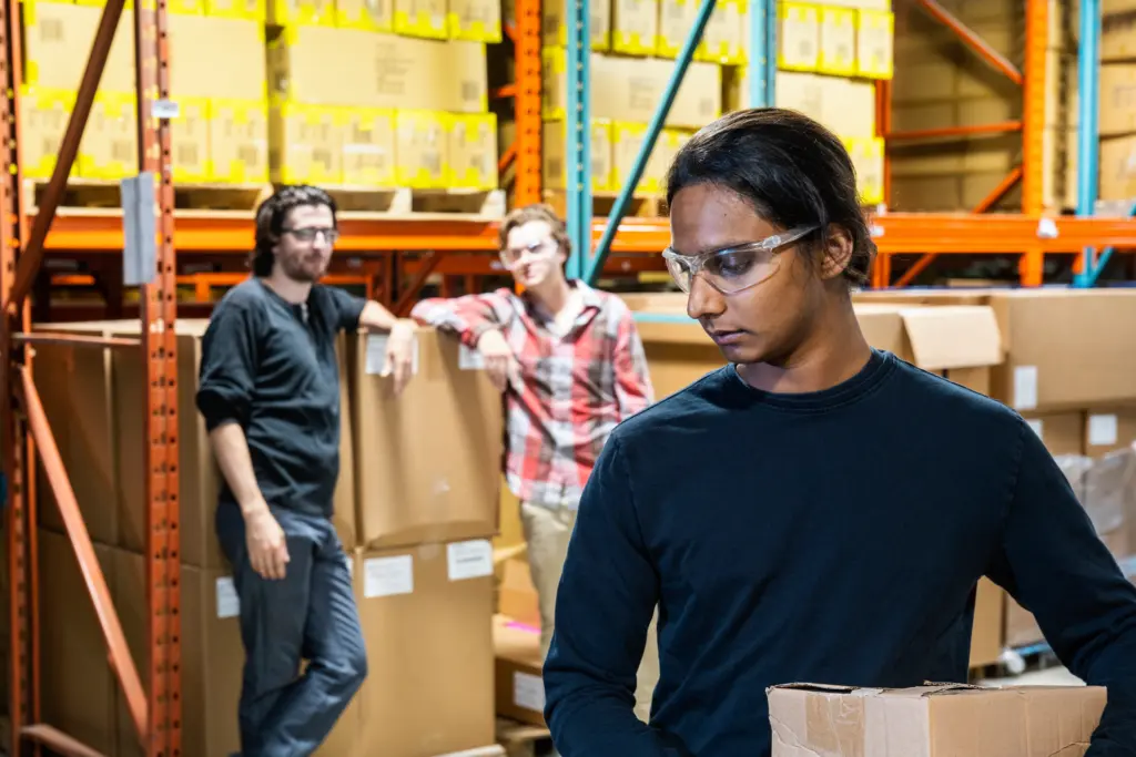 A colored employee getting mistreated by his coworkers.
