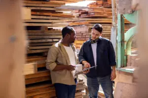 A worker is informing something to his coworker in private.