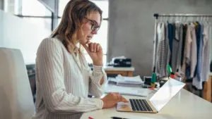 A woman looking at her computer for evidence.