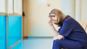 A nurse crying in the hallway.