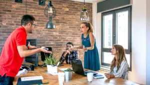 Two workers arguing during a meeting.