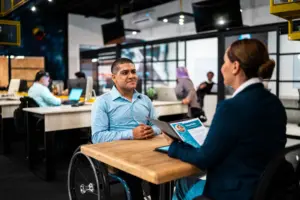 A disabled man interviewing for a job.
