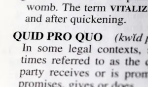 A close up of the definition "Quid Pro Quo".