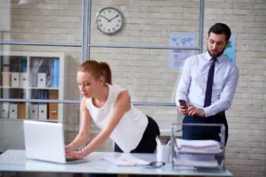 A man taking a photo of a woman's butt without her consent or knowledge. 