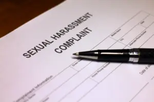 A sexual harassment compliant form with a pen on top.