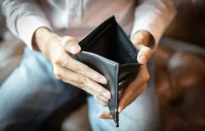 A man opening up a empty wallet.