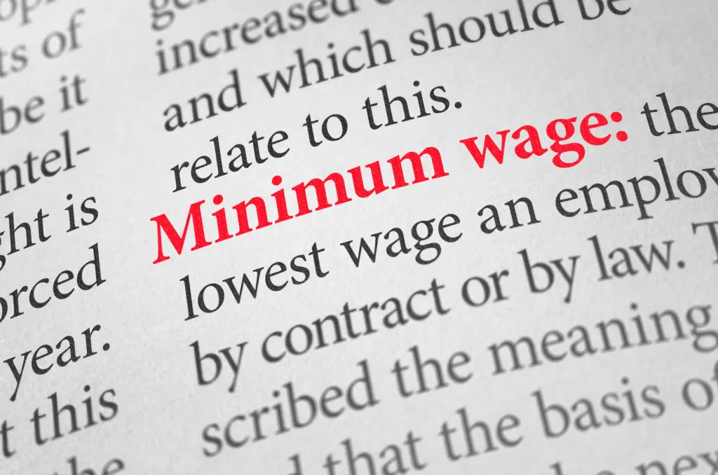 A close up definition of the word Minimum wage.