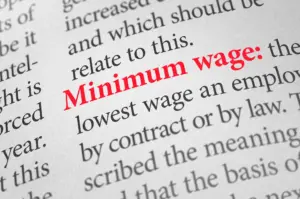 A close up definition of the word Minimum wage.