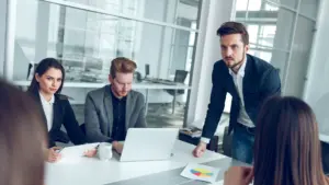 An angry supervisor staring down his employees.