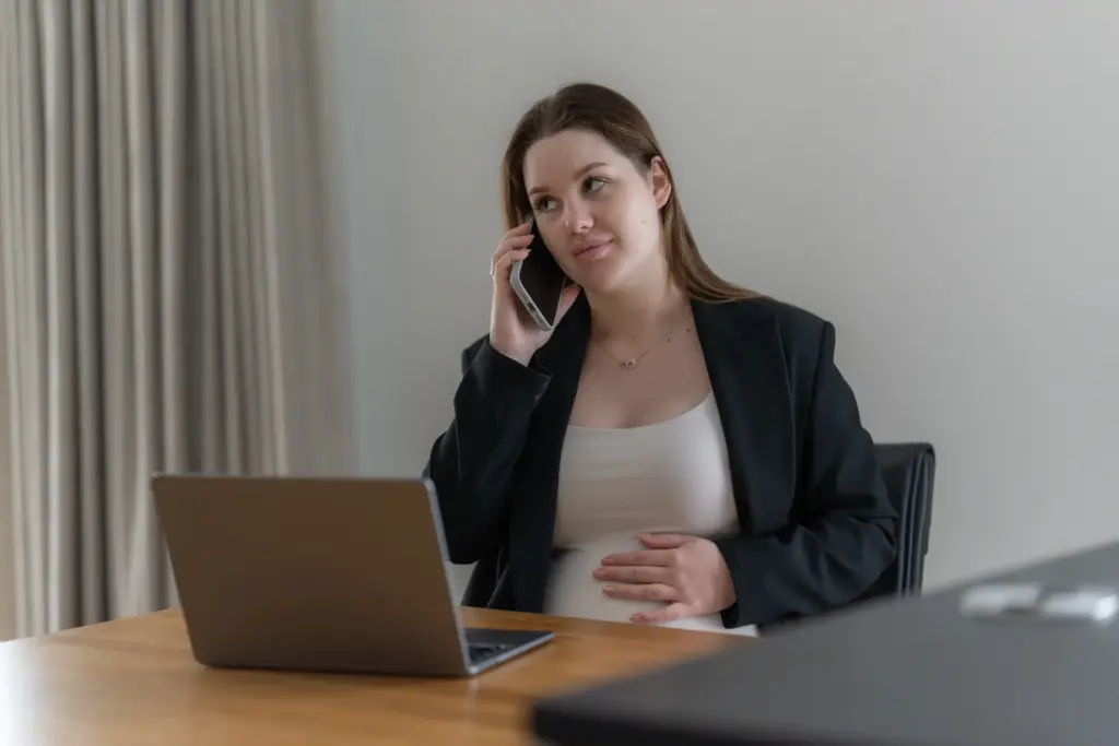 A pregnant woman calling in sick for work.