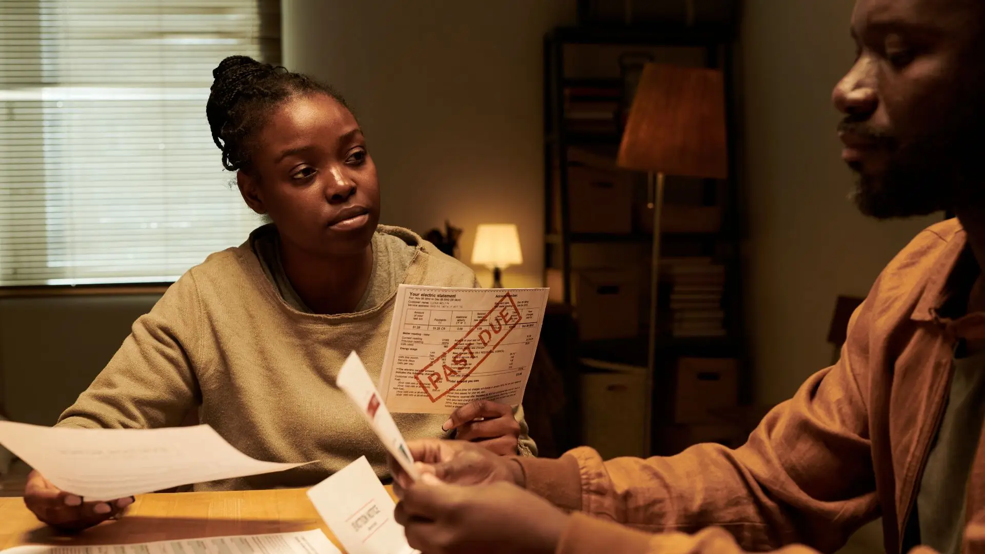A couple going through bills that are past due.