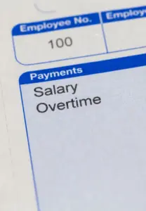 A close up of a person's salary and overtime. 
