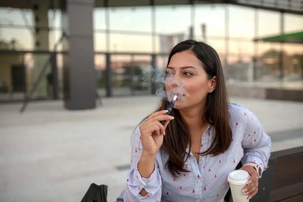 A woman taking a smoke break at her job. 