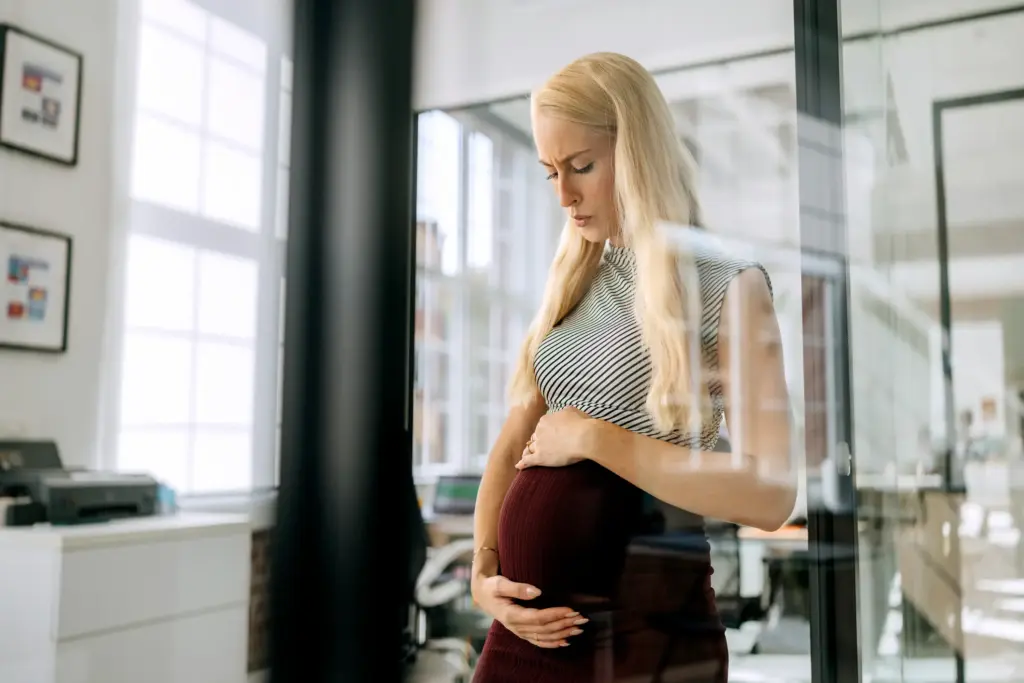 A fired pregnant woman worrying about her child's future.