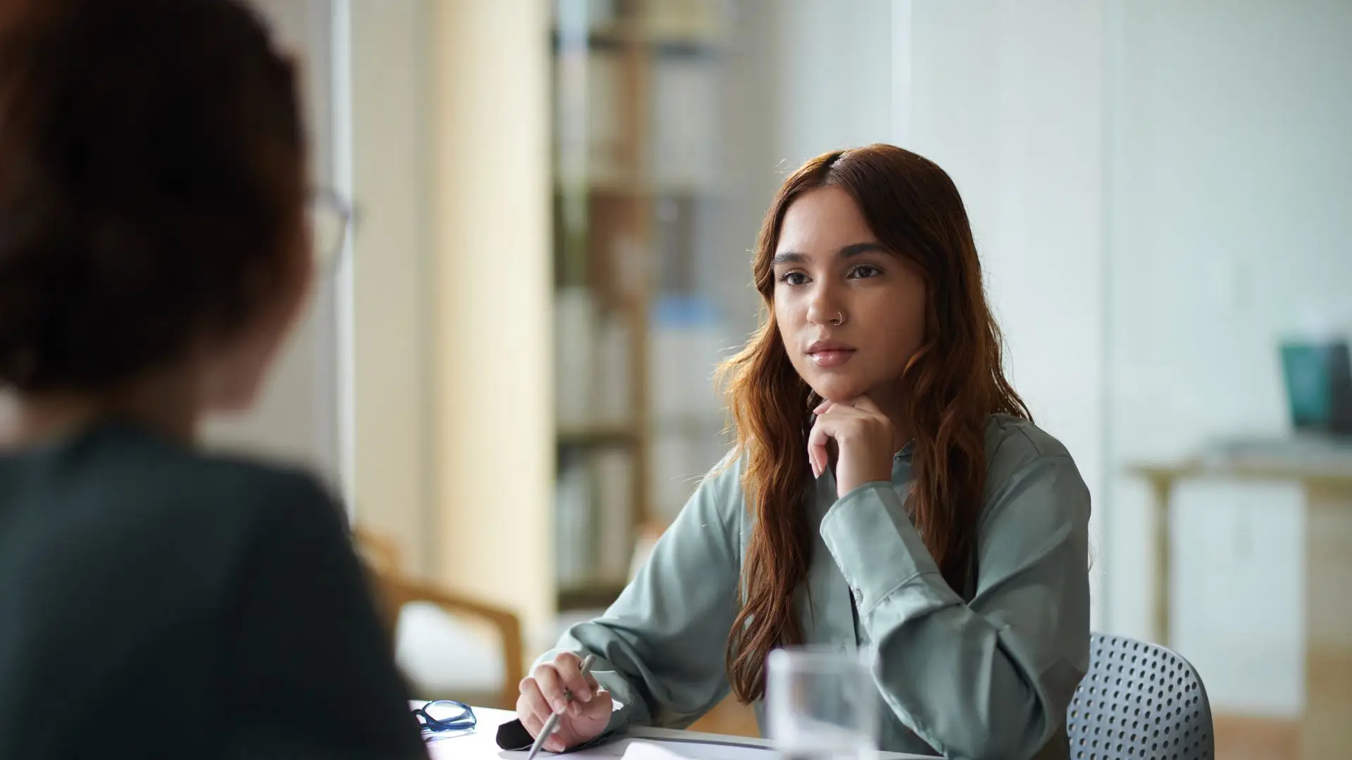 An HR rep at a company taking notes of an employee's concerns.