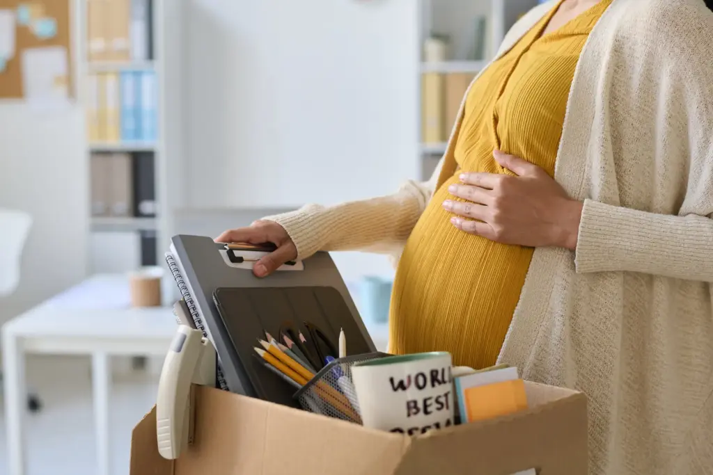 A fired pregnant worker packing up her things. 