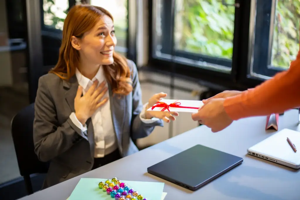 A woman getting a holiday bonus at her desk.