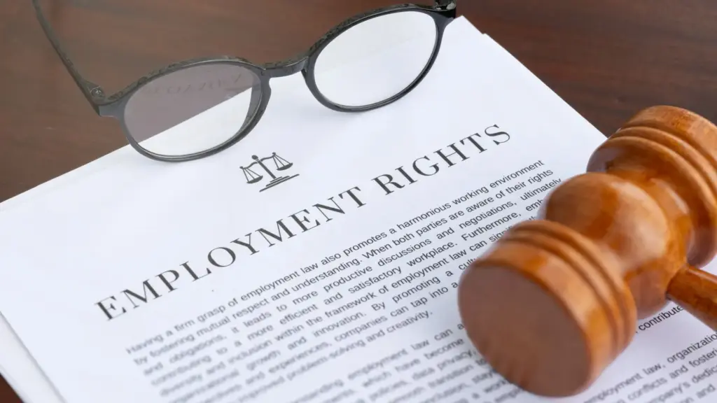 An employment rights document with a pair of glasses and gavel.