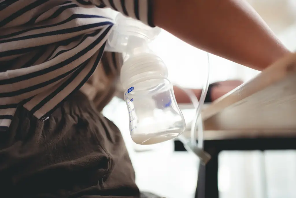 A woman pumping breast milk while working.