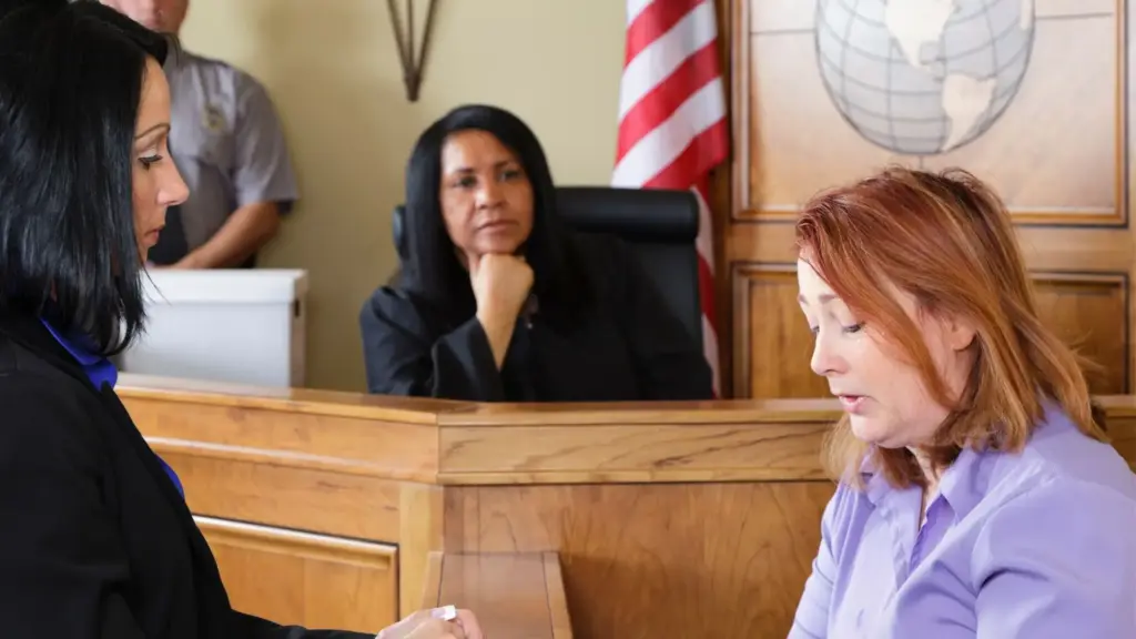 A woman answering questions at court.