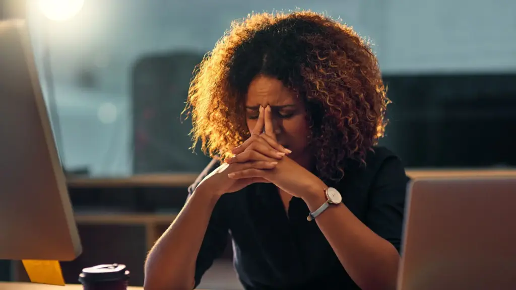 A woman stressing out that her employer is not paying her.