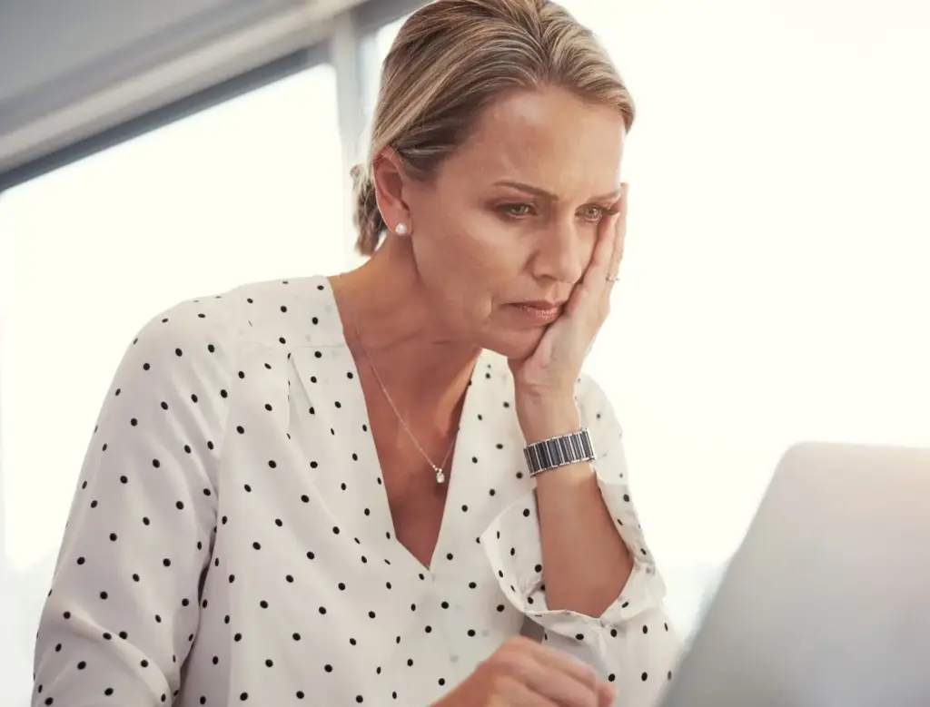 A worker learning that she is getting demoted via email. 