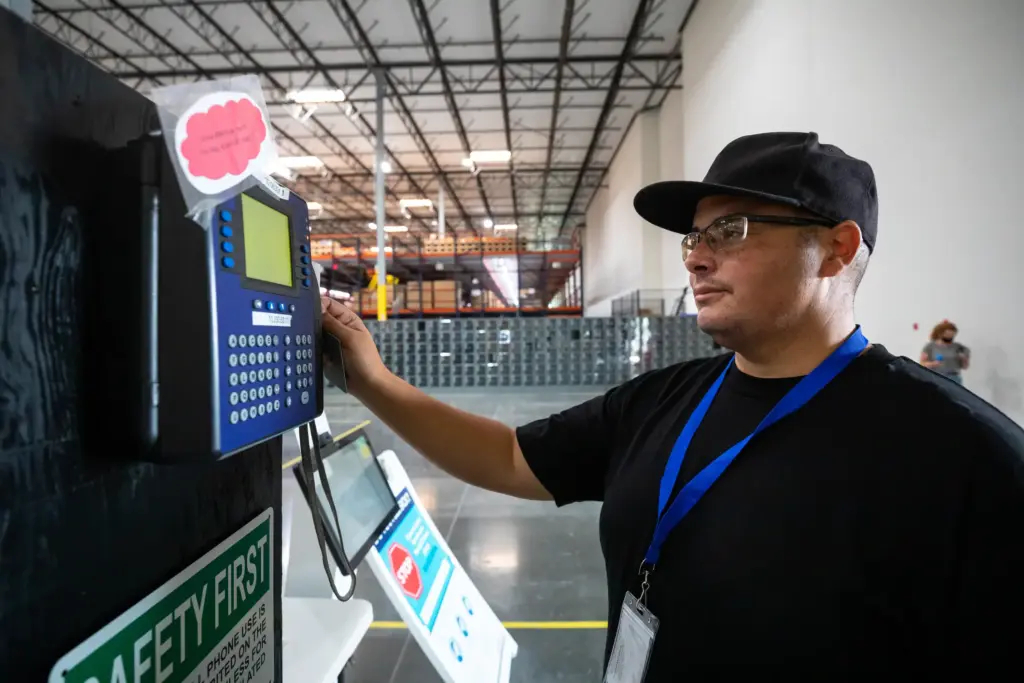 A warehouse worker clocking out on time.