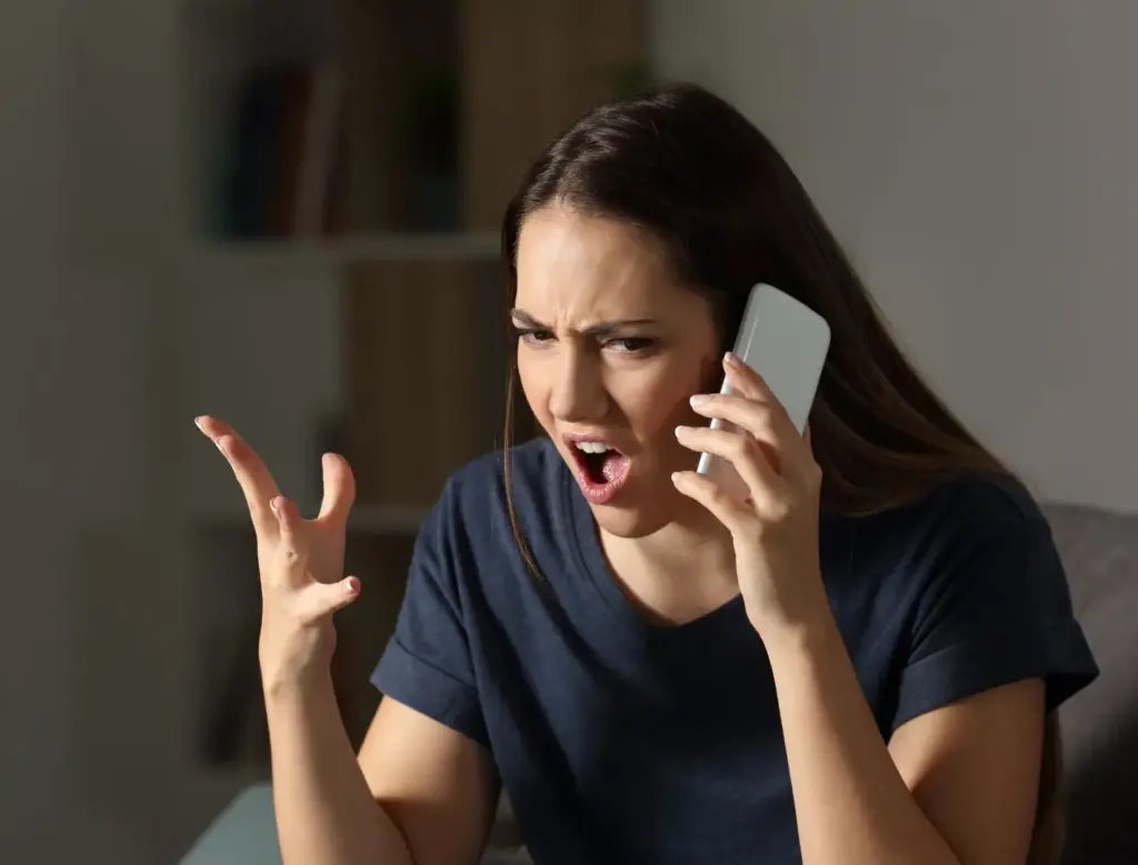 A woman being told that she is being demoted at her job.
