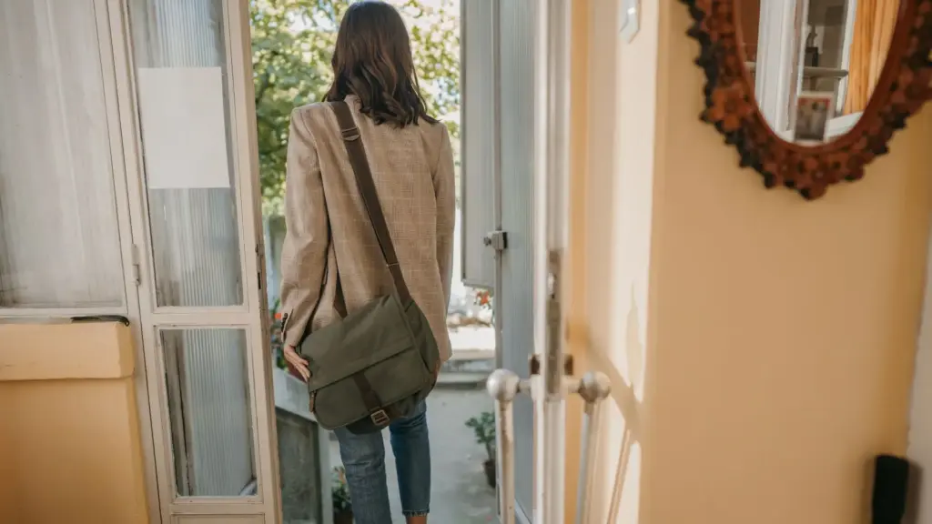 A woman leaving their apartment. 
