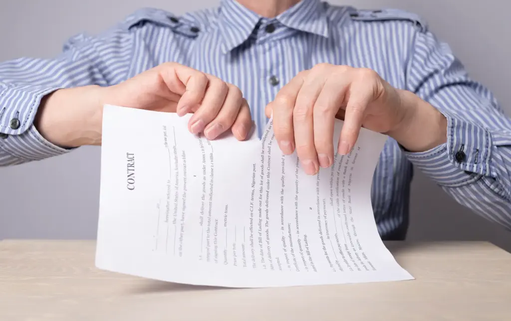 A person tearing up a contract.