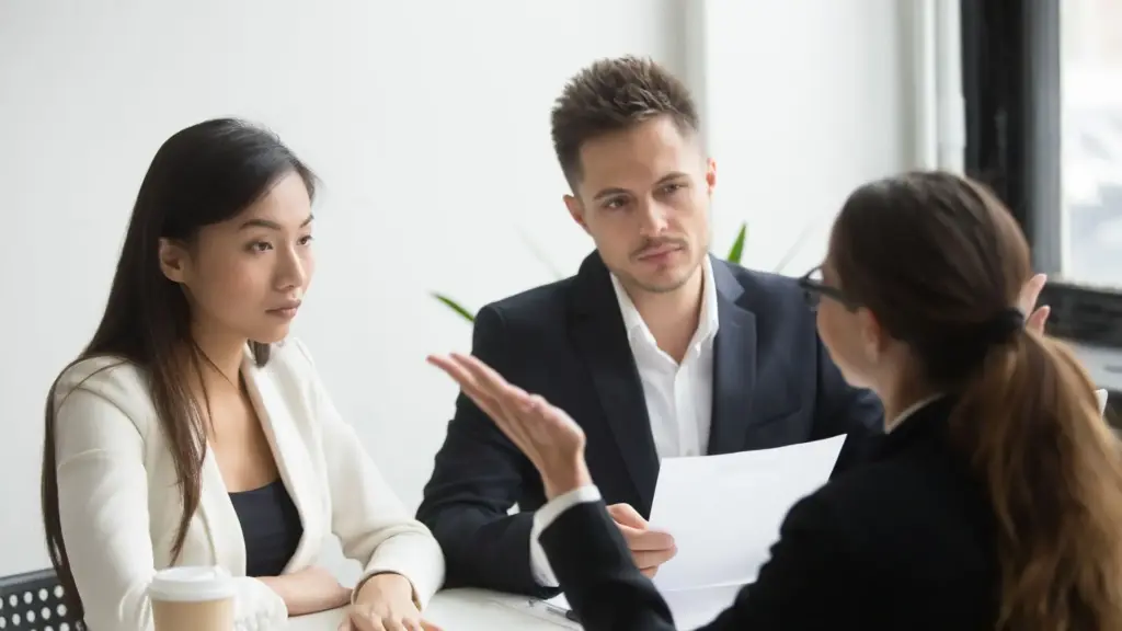 Two supervisors hearing why the employee in front of them should get insurance. 
