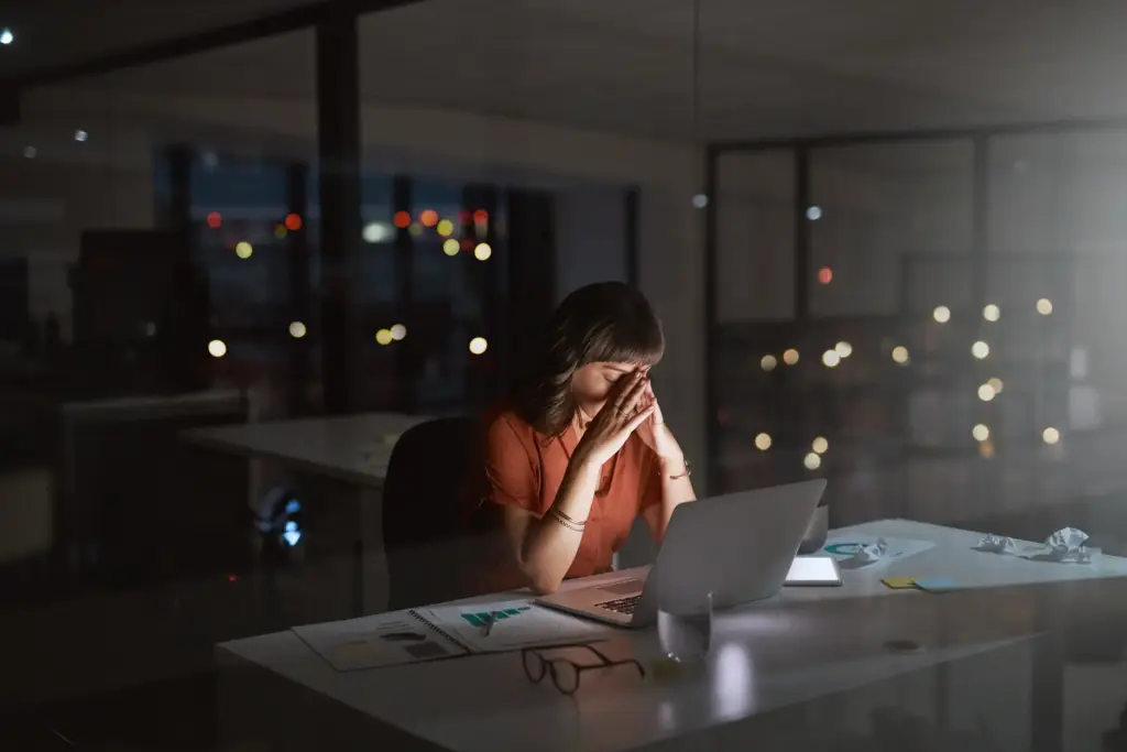A woman working late at work.