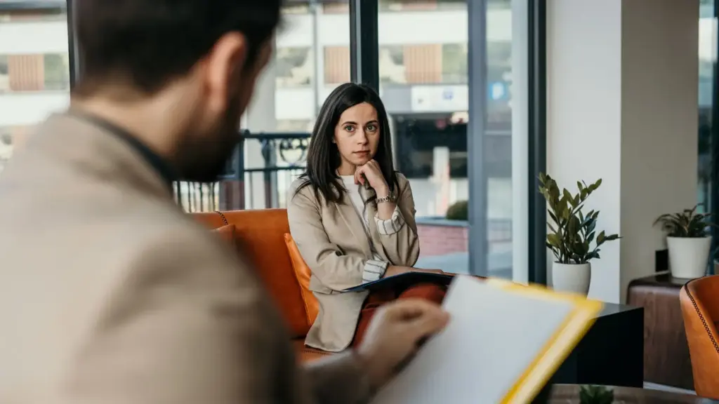 A nervous worker talking to her boss.