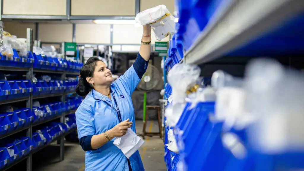 An hour pharmacy worker sorting out prescriptions. 