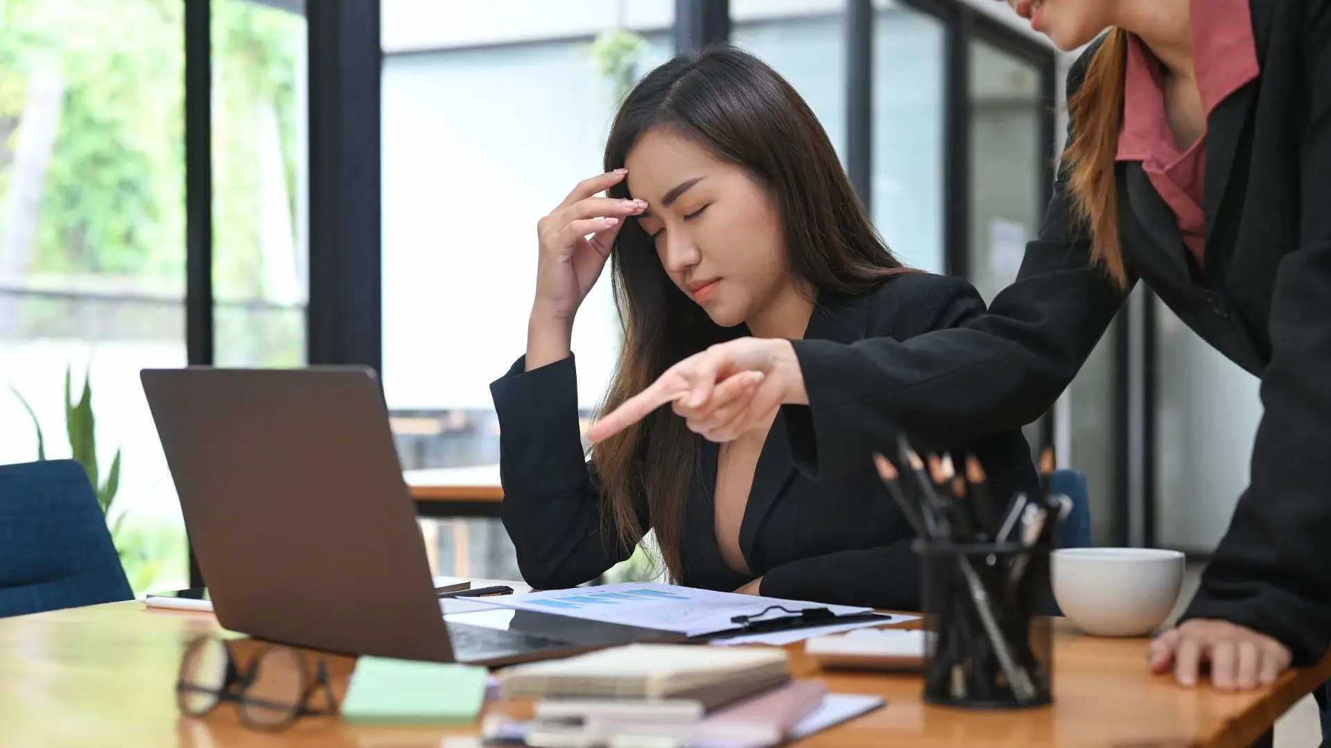 A woman getting scolded by her supervisor.