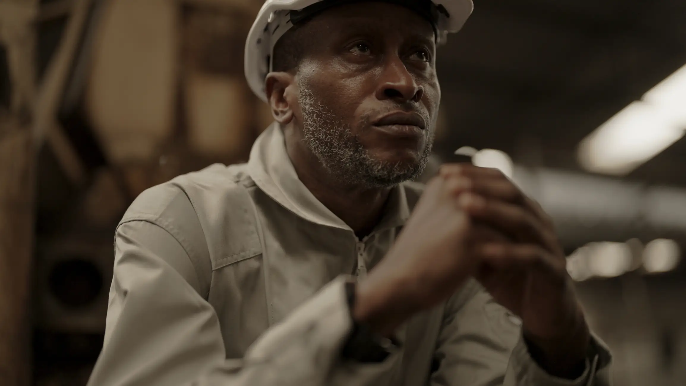 A old man with his hands together hoping for a higher wage.