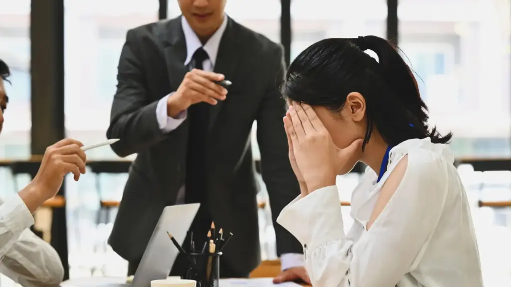 A female worker getting scolded. 