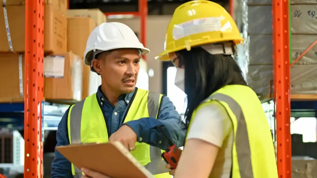 A warehouse supervisor scolding an employee.