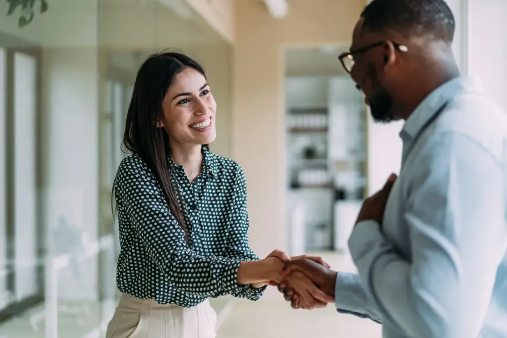 A man and a woman shaking hands.