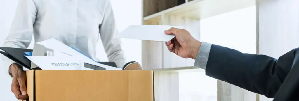 A boss handing a fired worker their last paycheck.