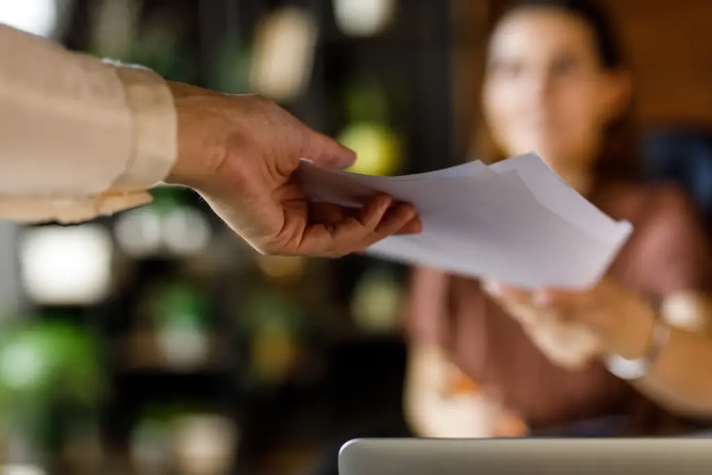 A woman getting served with papers. 