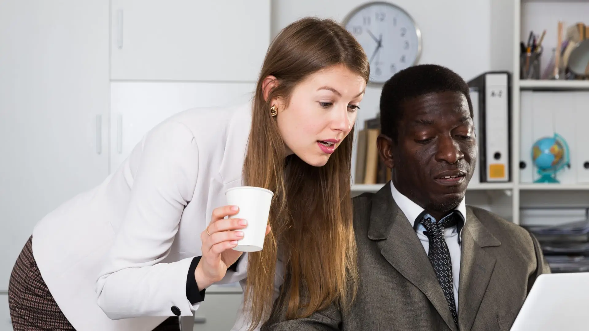 A woman getting very close to her supervisor.