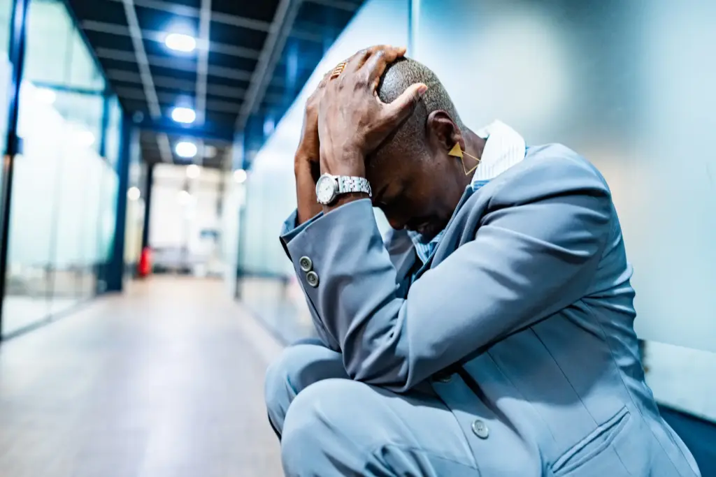A wrongfully terminated employee crying in the hallway.