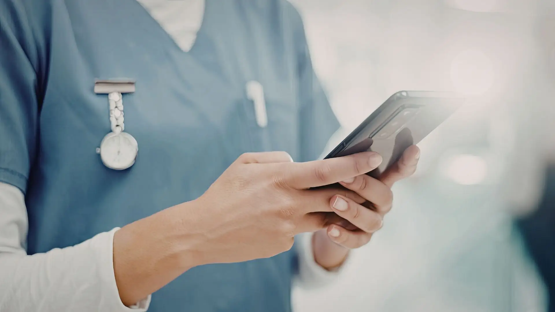 A nurse looking for an attorney on her phone.