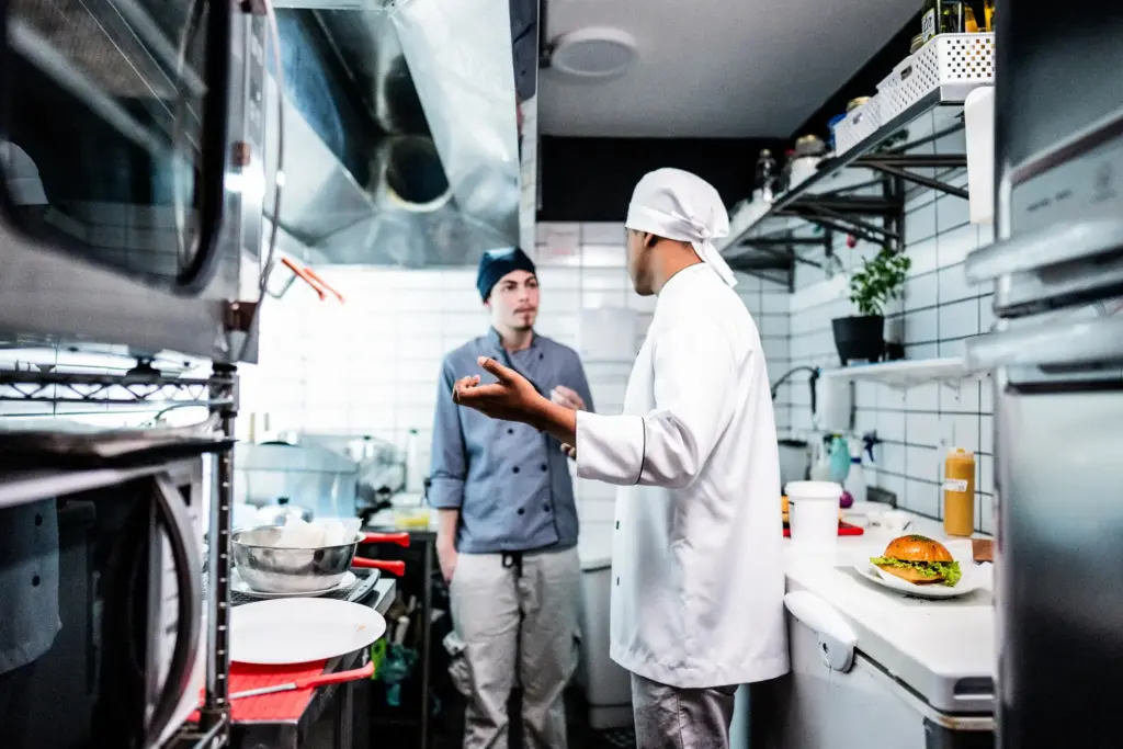 Two cooks arguing in the kitchen.