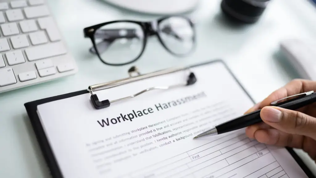 A person filling out a sexual harassment form.
