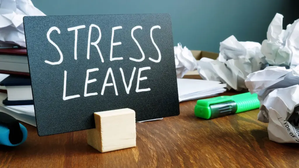 A sign that says "Stress Leave" surrounded by crumpled papers.