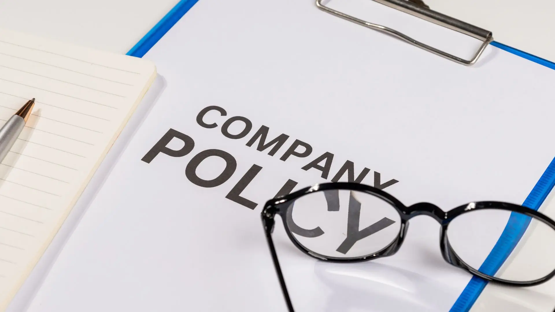 A company policy form on a clipboard.