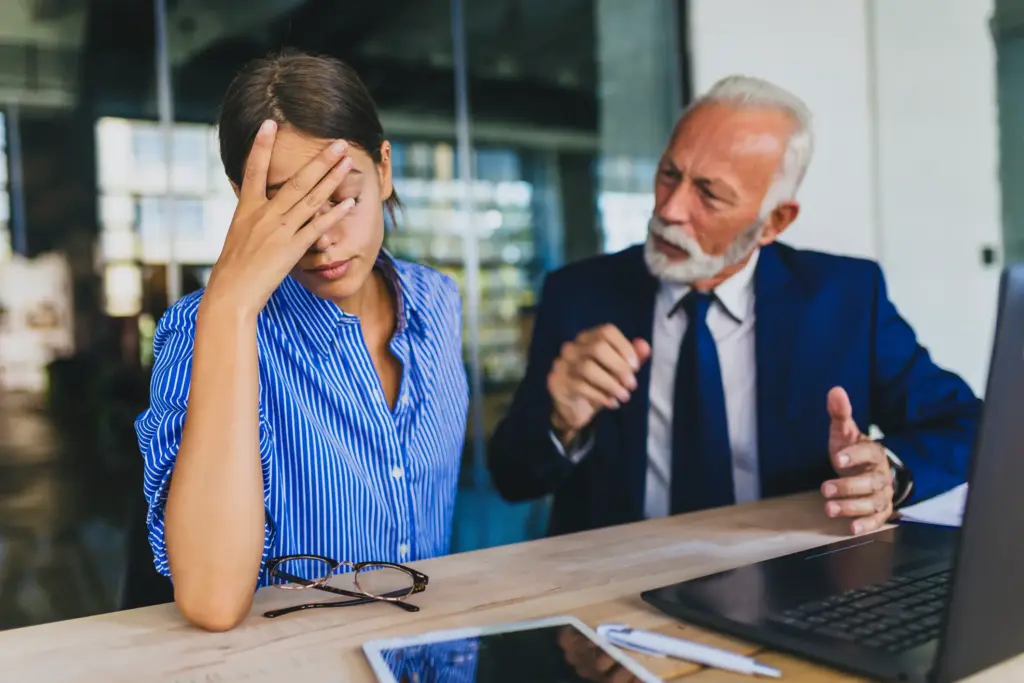 An office worker getting frustrated at her boss.